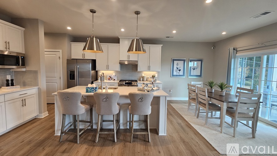 A modern kitchen with a dining table set for four.