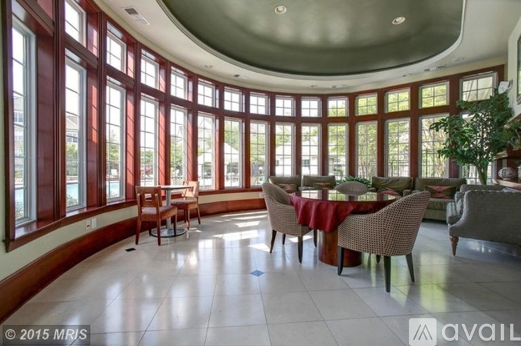 A dining room with a round table and chairs.