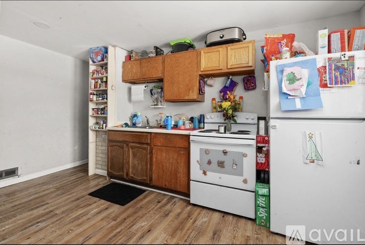 A kitchen with a white fridge and a white stove top oven.