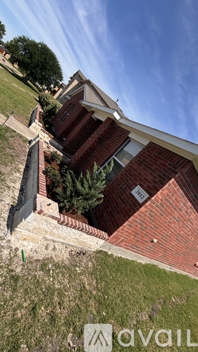 A house with a red brick exterior and a white roof.