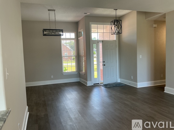 A room with a grey wall and a white door.