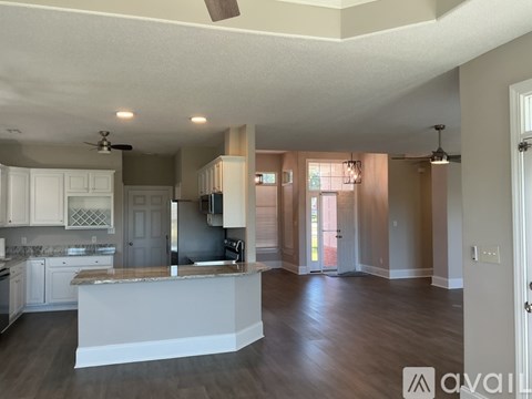 A kitchen with a white island in the middle of the room.