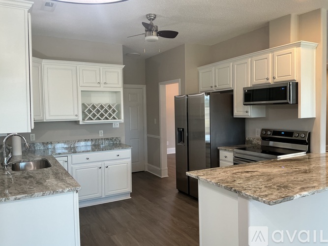 A kitchen with granite countertops and stainless steel appliances.