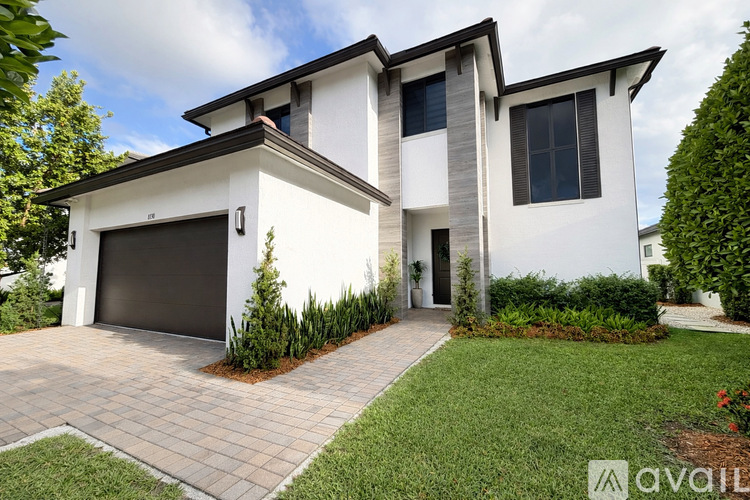 A modern house with a garage is for sale.