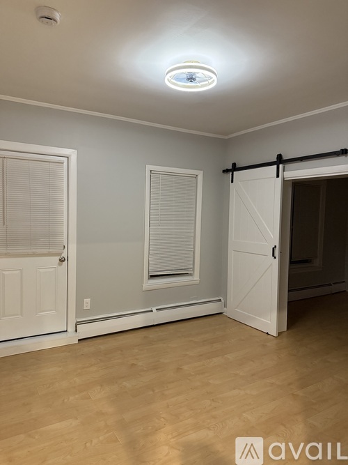 A room with a sliding door and a window with blinds.