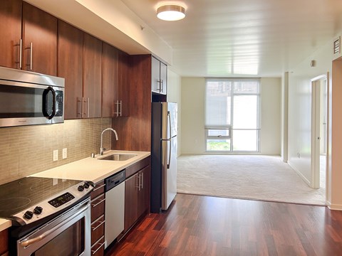 A kitchen with wooden cabinets and stainless steel appliances.