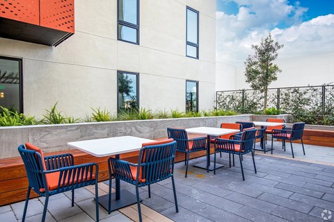 A patio with a table and chairs is set up outside a building.
