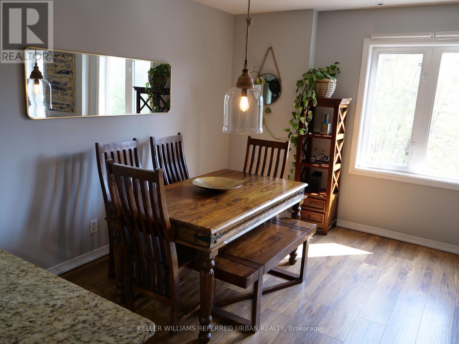 A dining room with a wooden table and chairs.