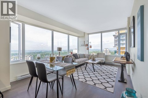 A modern living room with a glass table and chairs.