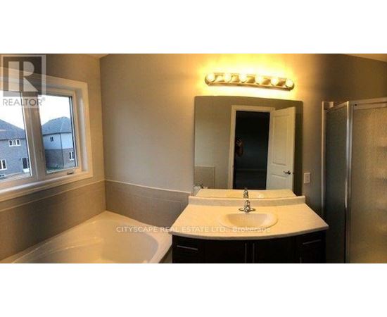 A bathroom with a sink, mirror, and a window.