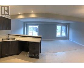 A realtor's office with a sink and cabinets.