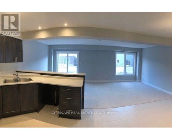 A realtor's office with a sink and cabinets.