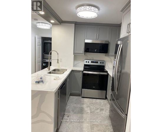 A modern kitchen with stainless steel appliances and a white countertop.