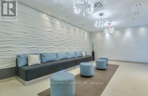 A modern living room with a grey sofa and a wooden coffee table.