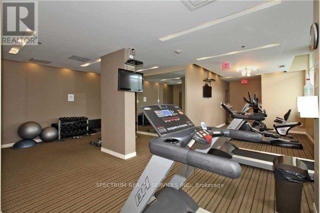 A gym room with a row of treadmills and exercise balls.