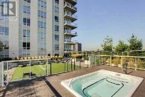 A large apartment complex with a pool in the foreground.