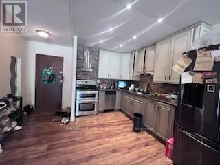 A kitchen with wooden floors and a large island.