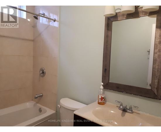 A bathroom with a sink, toilet, and bathtub.
