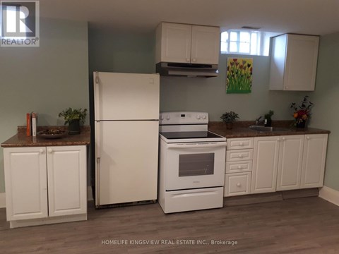 A kitchen with white appliances and cabinets.