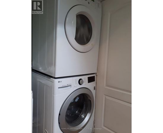 A white washing machine and dryer stacked on top of each other.
