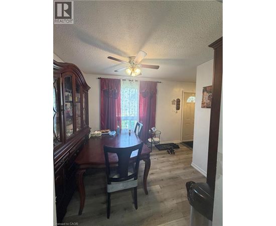 A dining room with a wooden table and chairs.