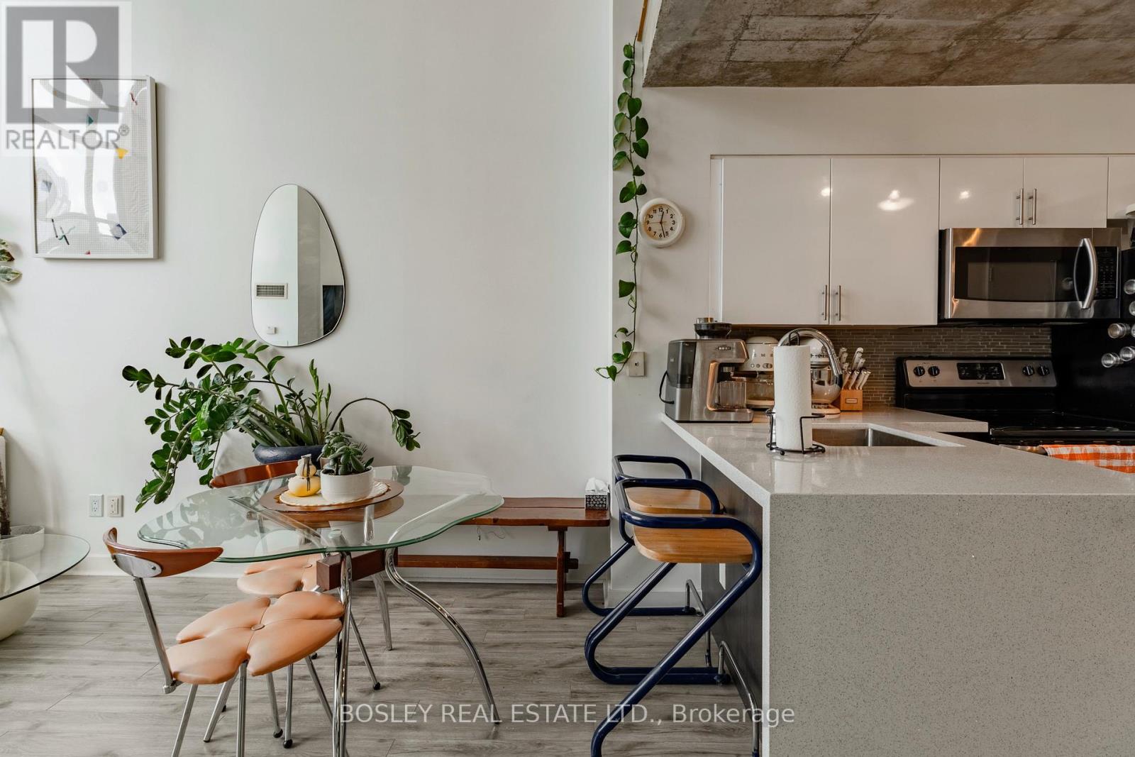 A modern kitchen with a glass table and chairs.