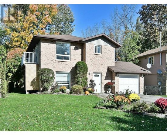 A house with a well-maintained lawn and a clear sky.