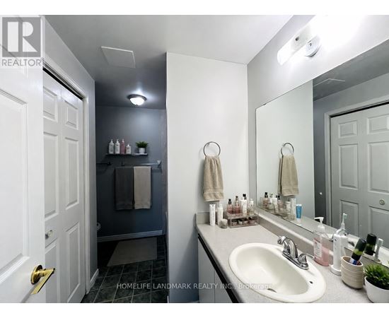 A bathroom with a white sink and a mirror.