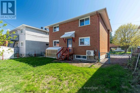 A house with a red brick exterior and a white garage door is for sale.