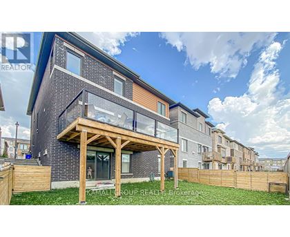 A modern house with a wooden deck in front.