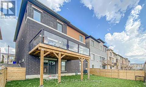 A modern house with a wooden deck in front.