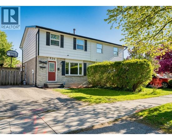 A house with the number 835 on it is for sale.