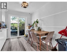 A dining room with a table and chairs and a broom.