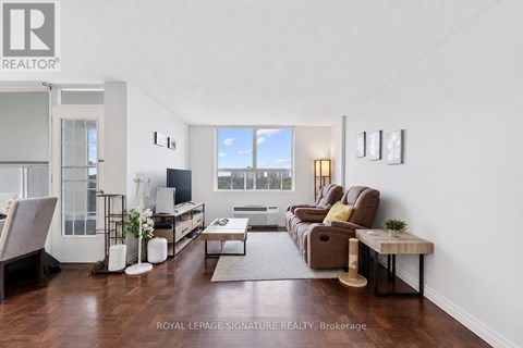 A living room with a brown couch and a coffee table.