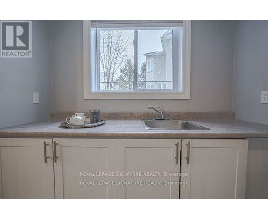 A kitchen with a sink and a window.