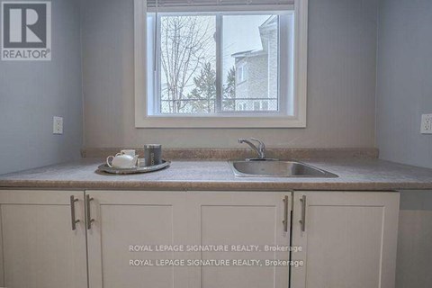 A kitchen with a sink and a window.