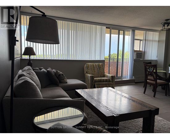 A living room with a couch, chair, and table.