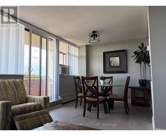 A dining room with a table set for two and a view of the outside.
