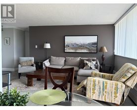 A living room with a couch, chair, and lamp.
