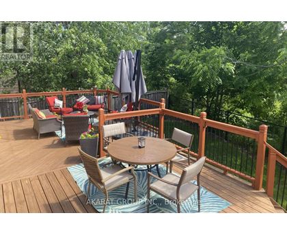 A wooden deck with a table and chairs.