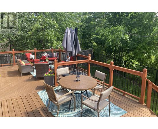 A wooden deck with a table and chairs.