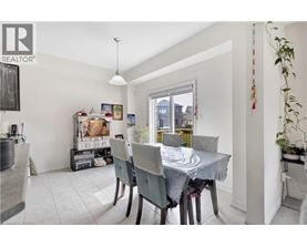 A dining room with a table set for four.