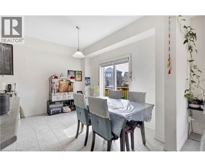 A dining room with a table set for four.