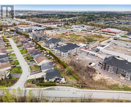 A bird's eye view of a residential area with a road running through it.