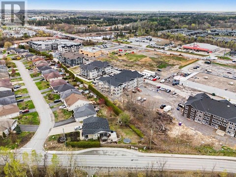 A bird's eye view of a residential area with a road running through it.