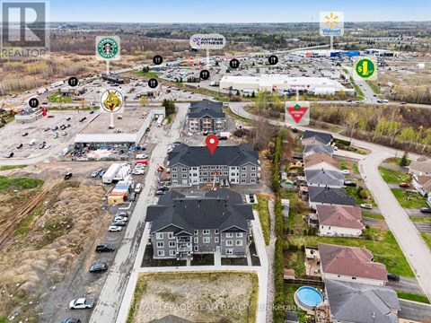 A bird's eye view of a neighborhood with a Walmart in the background.