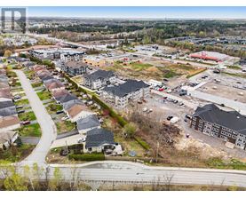 A bird's eye view of a residential area with a road running through it.