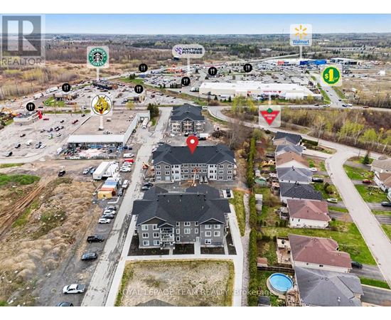 A bird's eye view of a neighborhood with a Walmart in the background.