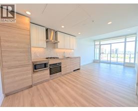 A modern kitchen with wooden floors and cabinets.
