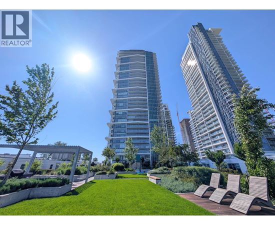 A sunny day in a city park with tall buildings in the background.